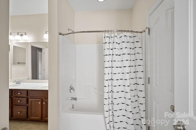 bathroom featuring vanity and shower / bath combo with shower curtain