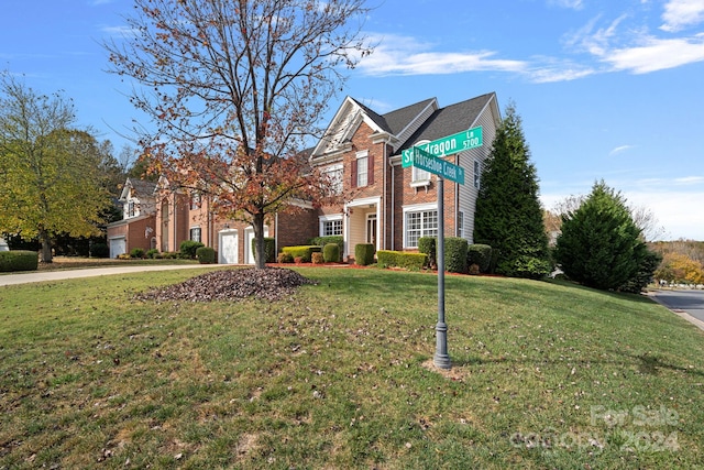 view of front of house featuring a garage and a front lawn