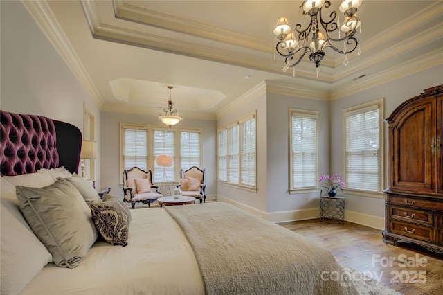 bedroom featuring crown molding, a tray ceiling, and hardwood / wood-style floors