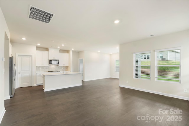 unfurnished living room with dark hardwood / wood-style flooring