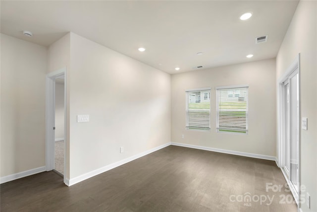 spare room featuring dark wood-type flooring