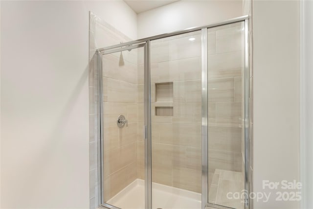 bathroom with a shower with door