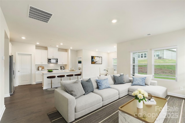 living room featuring dark wood-type flooring