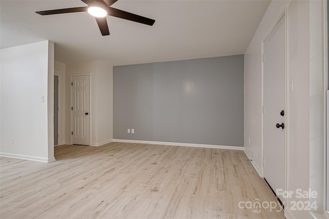 unfurnished room with light wood-type flooring and ceiling fan