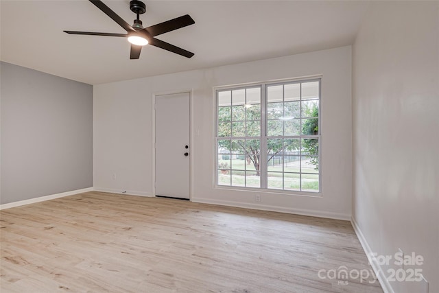 spare room with ceiling fan and light wood-type flooring