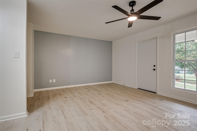 foyer entrance with ceiling fan, a wealth of natural light, and light wood-type flooring