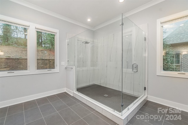 bathroom with tile patterned floors, a shower with shower door, and ornamental molding