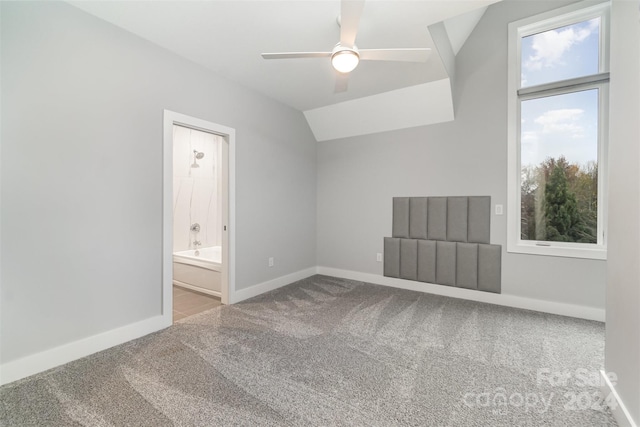 carpeted spare room featuring ceiling fan and lofted ceiling