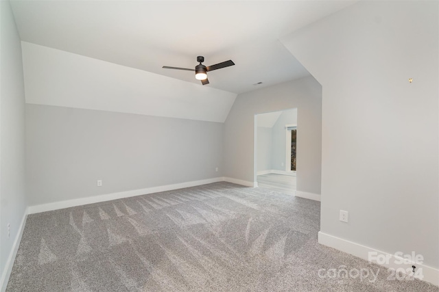 additional living space featuring carpet, ceiling fan, and vaulted ceiling