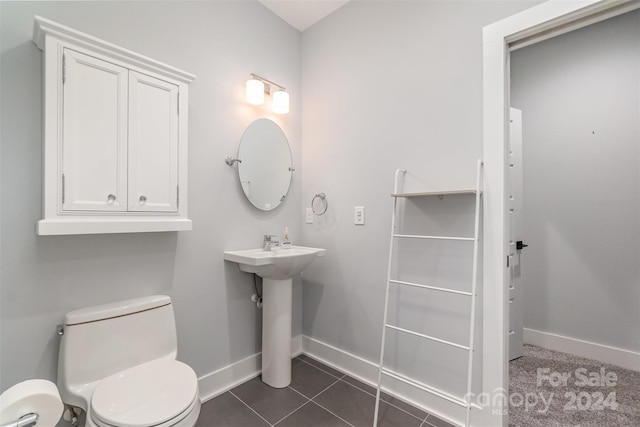 bathroom with toilet and tile patterned floors