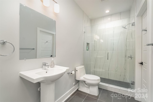 bathroom with tile patterned flooring, toilet, and an enclosed shower