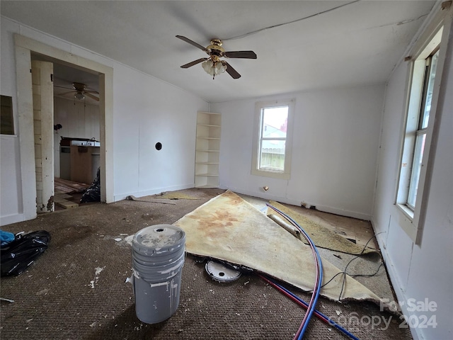 interior space featuring ceiling fan and carpet floors