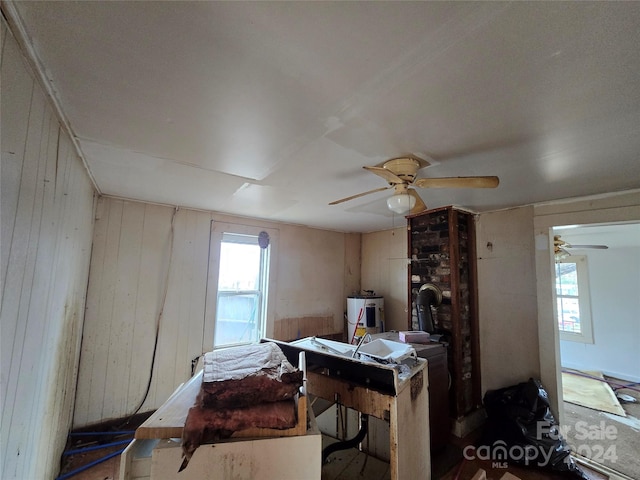 interior space featuring electric water heater, a wealth of natural light, and ceiling fan