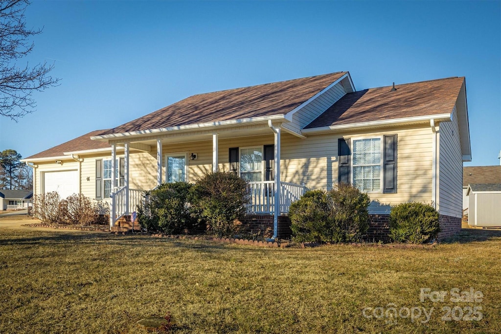 view of front of property with a garage, a front yard, covered porch, and central air condition unit