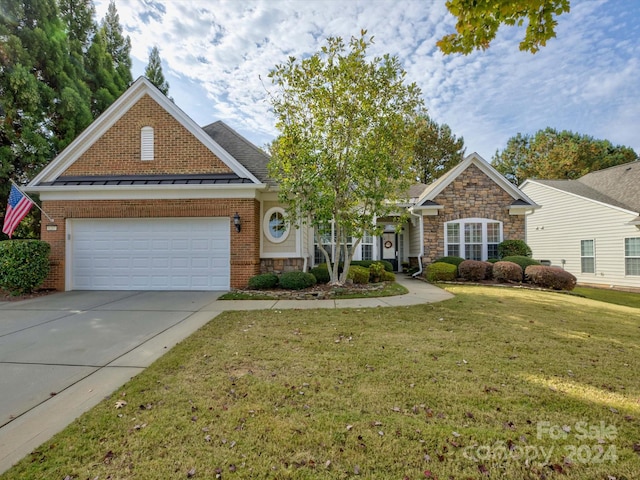 view of front facade with a garage and a front yard