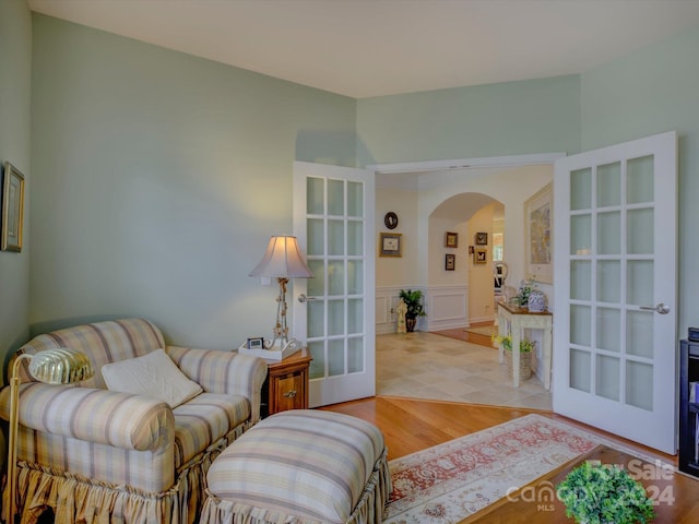 living room with french doors and light hardwood / wood-style flooring