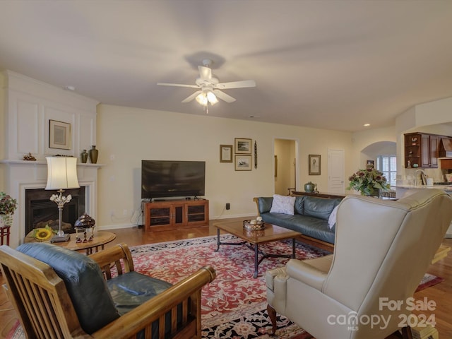 living room with ceiling fan and light wood-type flooring