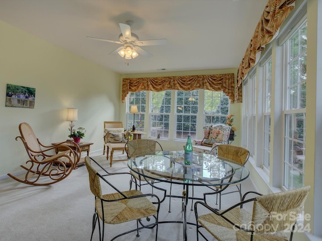 carpeted dining space featuring a healthy amount of sunlight and ceiling fan