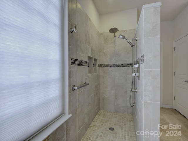 bathroom with tile patterned floors and tiled shower