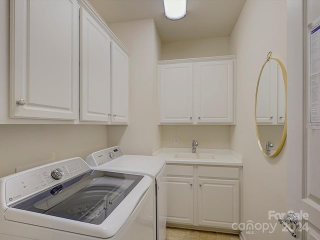 laundry area with cabinets, sink, and washer and clothes dryer