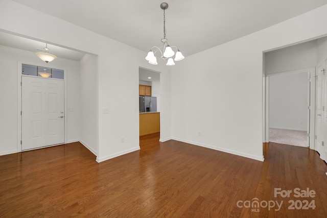 interior space with dark hardwood / wood-style flooring and a notable chandelier