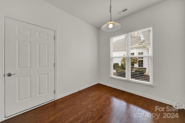 empty room featuring dark wood-type flooring