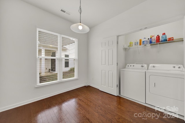 washroom featuring dark hardwood / wood-style floors and washer and clothes dryer