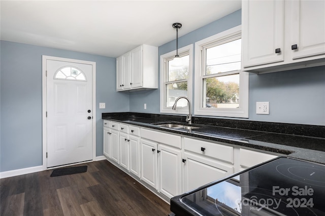 kitchen featuring white cabinets, plenty of natural light, and decorative light fixtures