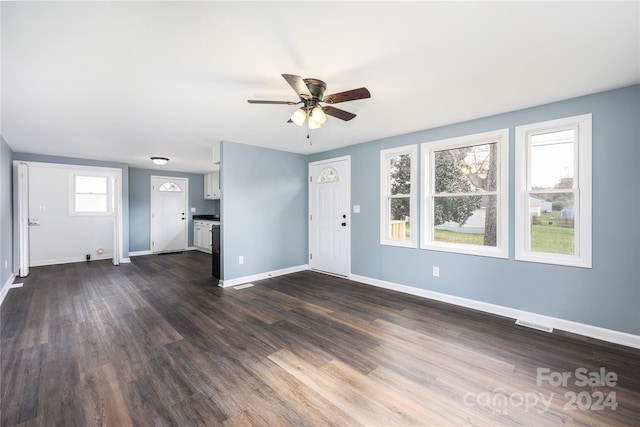 unfurnished living room with ceiling fan and dark hardwood / wood-style floors