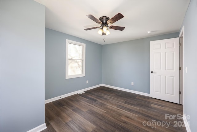 empty room with ceiling fan and dark hardwood / wood-style floors