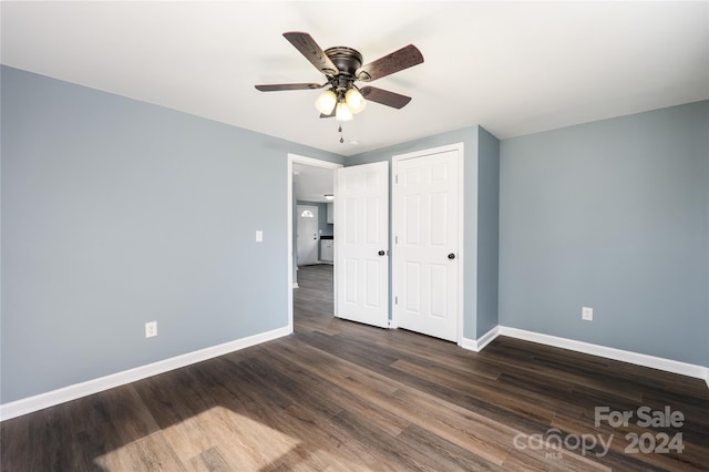 unfurnished bedroom featuring ceiling fan and dark hardwood / wood-style floors