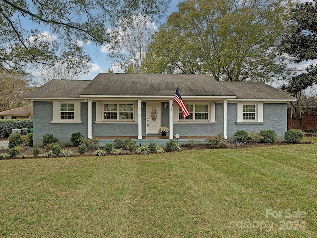 ranch-style house with a front lawn and covered porch