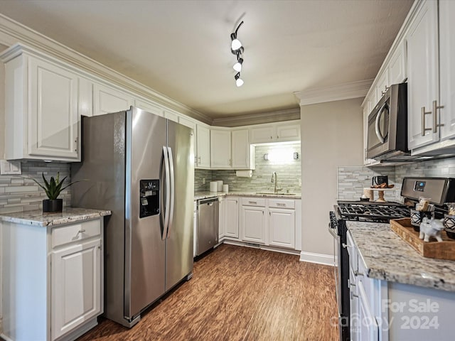 kitchen with white cabinets, decorative backsplash, dark hardwood / wood-style floors, and appliances with stainless steel finishes