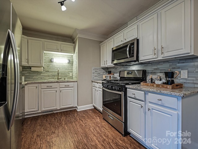 kitchen featuring white cabinets, decorative backsplash, stainless steel appliances, and sink