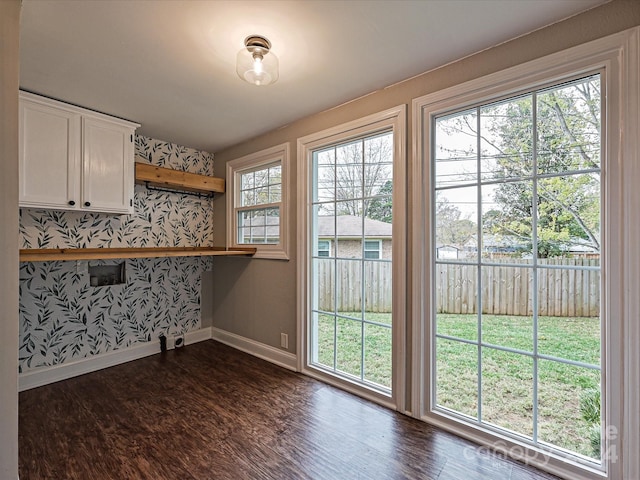 doorway with dark hardwood / wood-style flooring and plenty of natural light