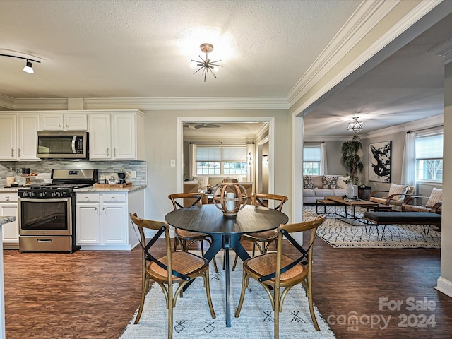 dining area with a textured ceiling, dark hardwood / wood-style flooring, and ornamental molding