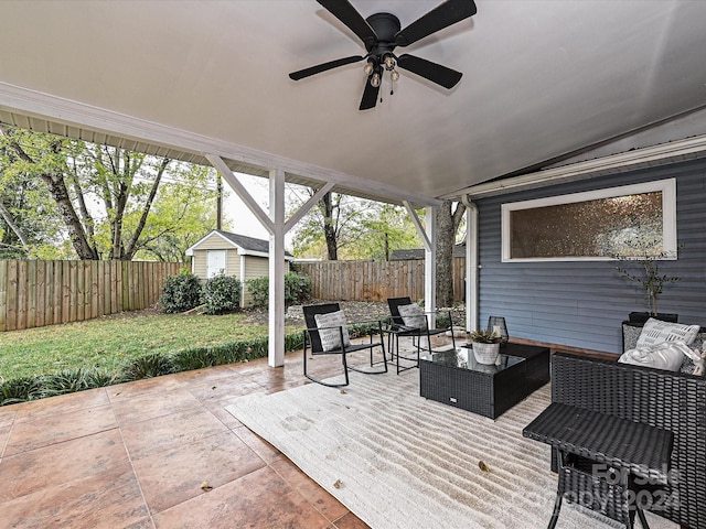 wooden terrace featuring an outdoor living space, a patio, and a storage shed