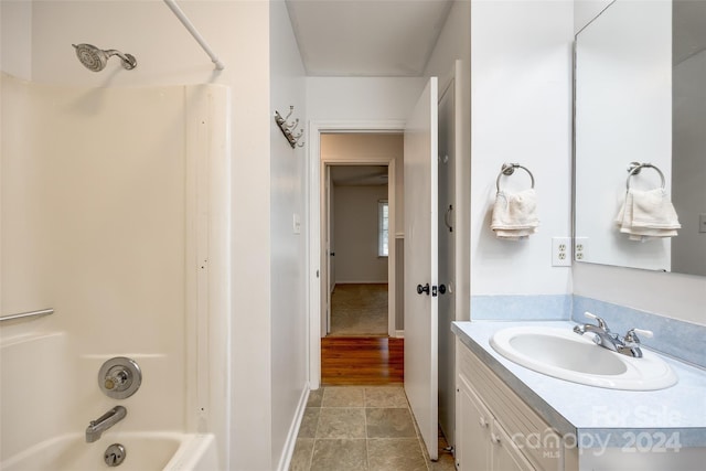 bathroom featuring shower / bathing tub combination, vanity, and tile patterned flooring