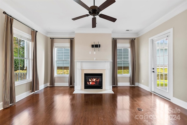 unfurnished living room featuring a wealth of natural light, dark hardwood / wood-style floors, and crown molding