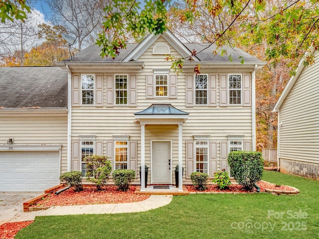 view of front of property featuring a front lawn and a garage