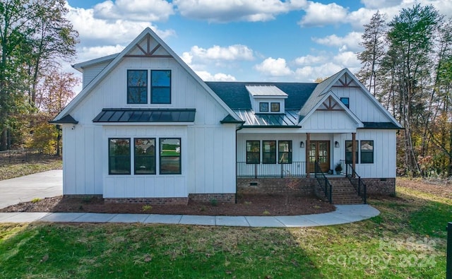 modern inspired farmhouse featuring a porch and a front lawn