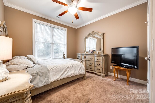 carpeted bedroom featuring ornamental molding and ceiling fan