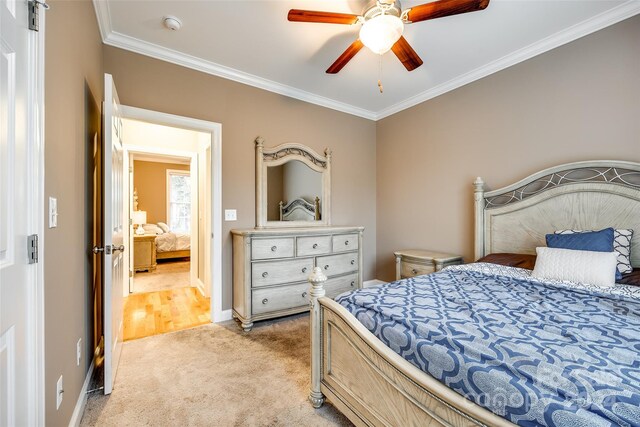 carpeted bedroom featuring ceiling fan and ornamental molding