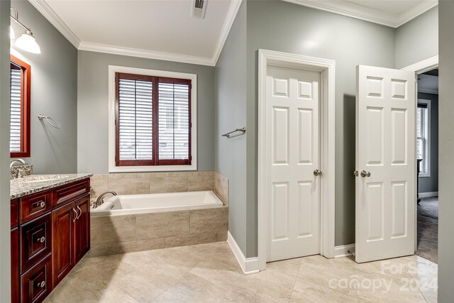 bathroom with a relaxing tiled tub, vanity, tile patterned floors, and ornamental molding