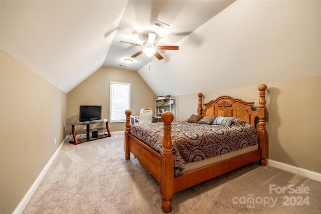 bedroom with lofted ceiling, light carpet, and ceiling fan