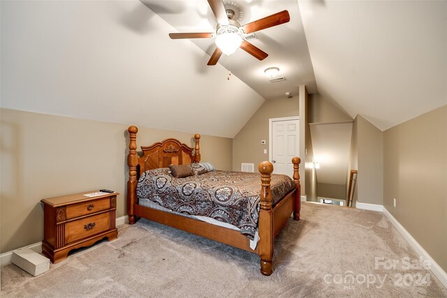 carpeted bedroom with ceiling fan and lofted ceiling