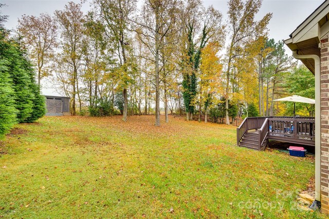 view of yard featuring an outbuilding and a deck