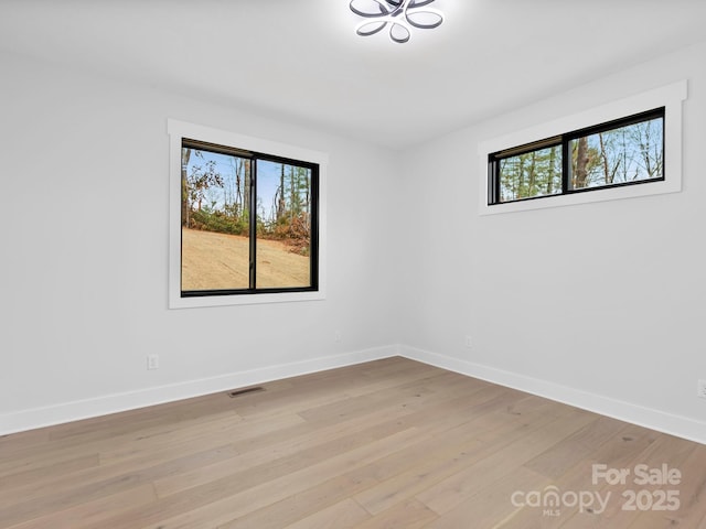 unfurnished room featuring light hardwood / wood-style floors