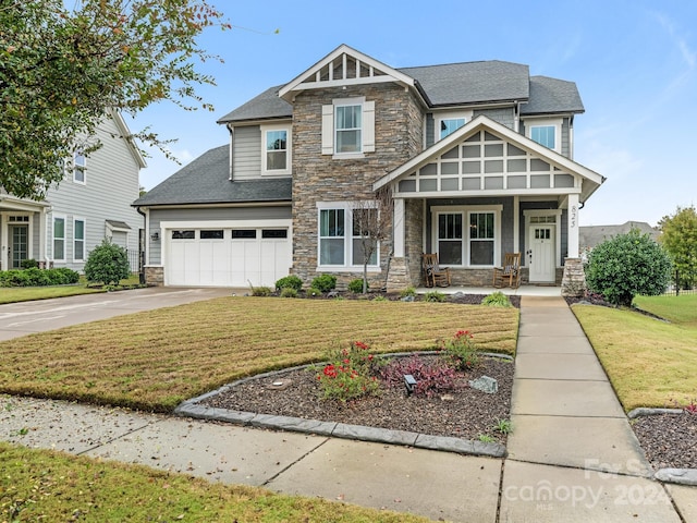 craftsman inspired home with a garage, a front lawn, and a porch