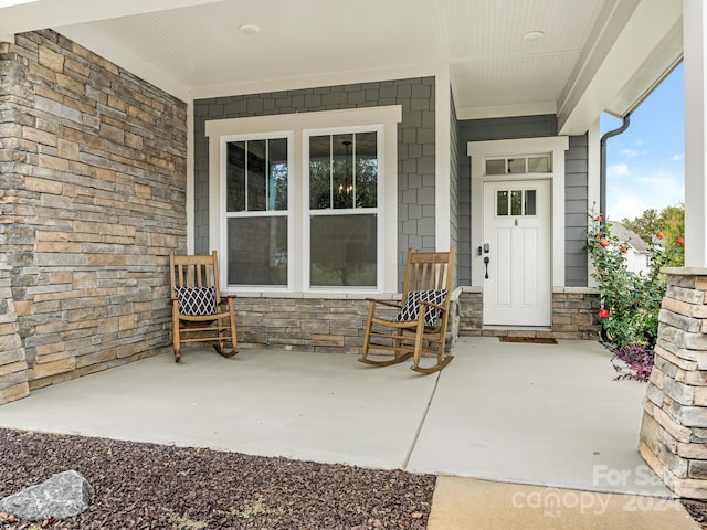 doorway to property featuring covered porch